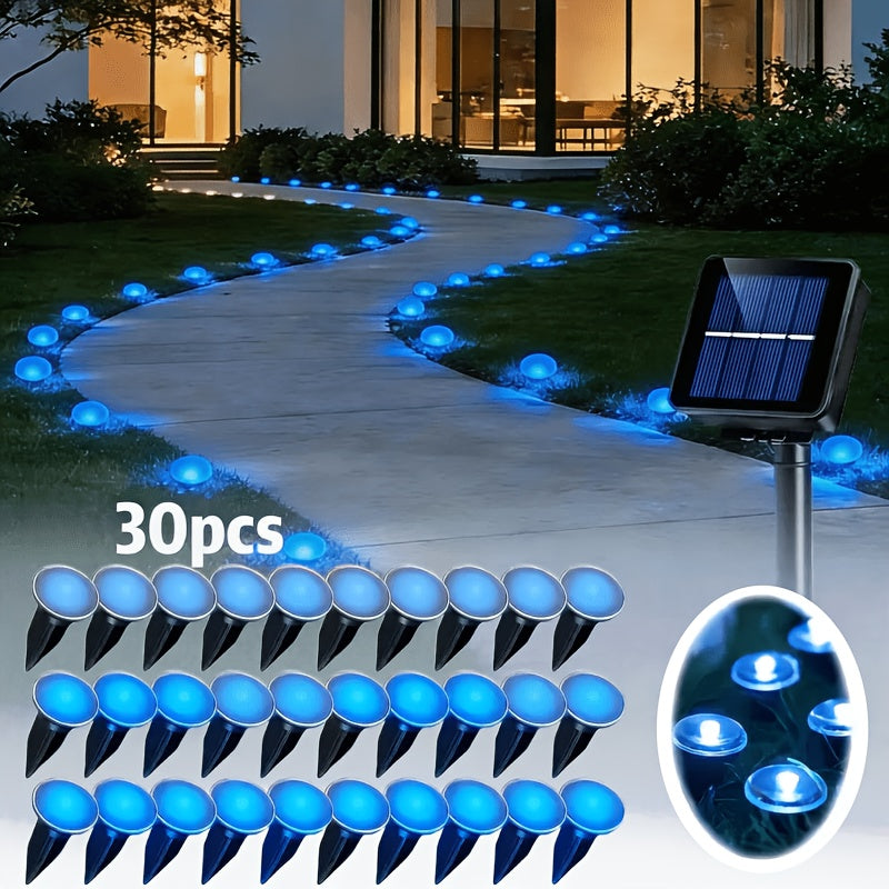 30-LED solar stake light glowing along a garden pathway at night