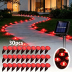 Solar pathway lights lining a walkway in assorted colors