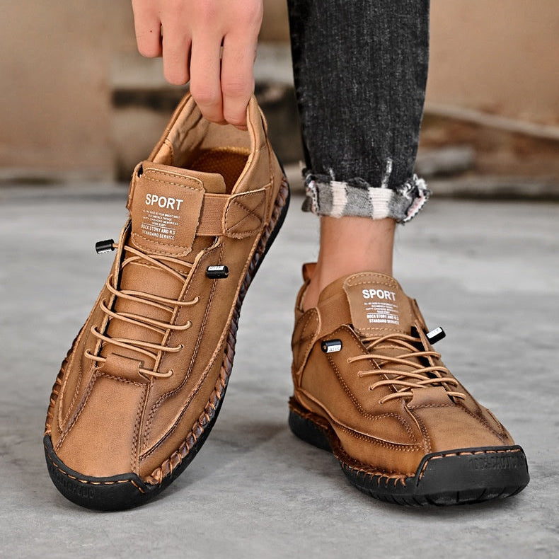 Person wearing brown leather shoes with 'New Journey' branding, standing on a gray floor.

